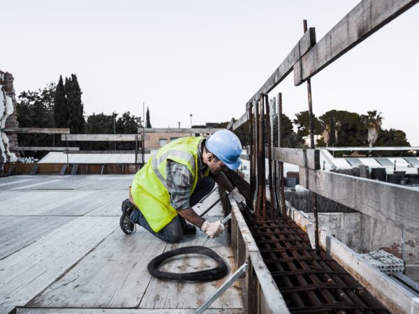 A worker prepares a formwork in a building under construction.