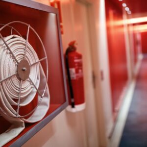 Fire extinguisher and hose reel in hotel corridor