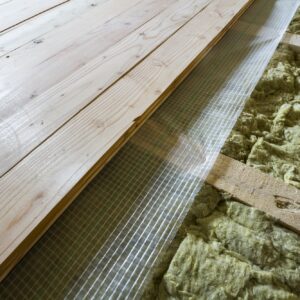 Installation of new floor of wooden natural planks and mineral wool insulation for isolation