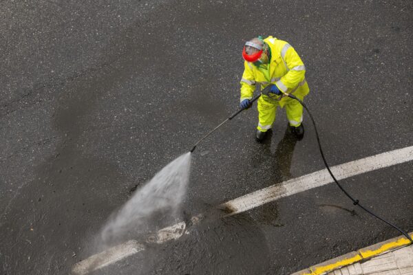 Worker cleaning a city road